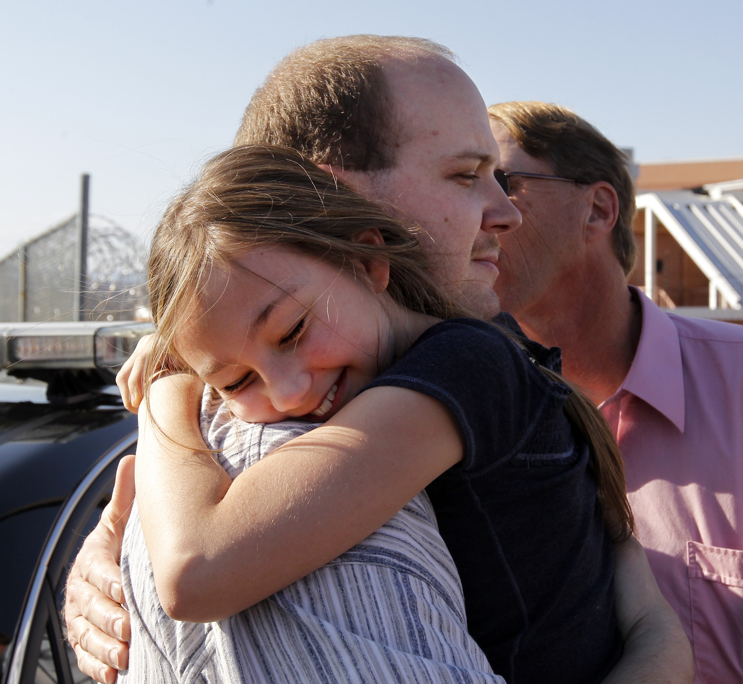Sabrina Hash, 9, hugs her uncle, Michael Wayne Hash after his release from the Albemarle RegionaJail Wednesday, March 14, 2012. His conviction for a 1996 killing was overturned earlier by a judge citing police and prosecutorial misconduct. At right is his father, Douglas Hash.