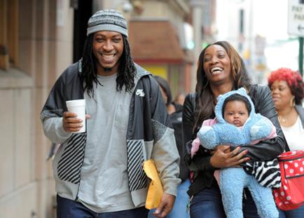 Sabein Burgess (L) walks with Latasha McFadden and their granddaughter, Gabrielle Davis, 5 months-old, after he was set free. 